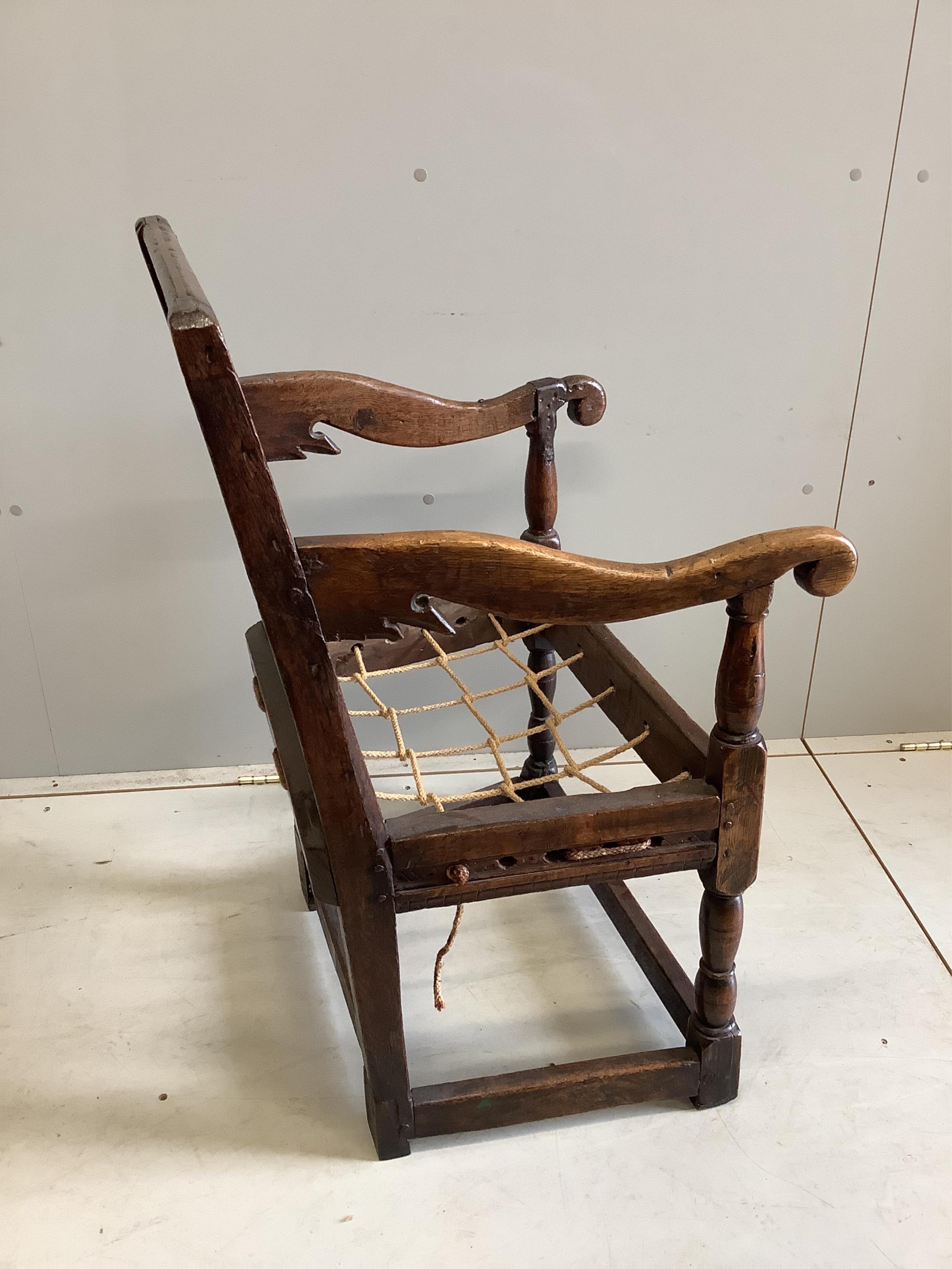 A 17th century oak wainscot elbow chair, width 56cm, depth 52cm, height 89cm. Condition - poor-fair